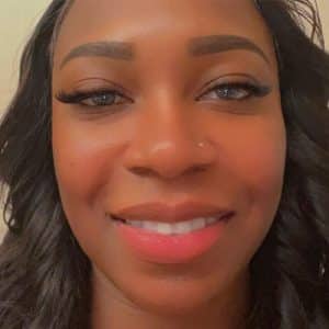 A Close Up Of A Woman Who Is Smiling At The Camera